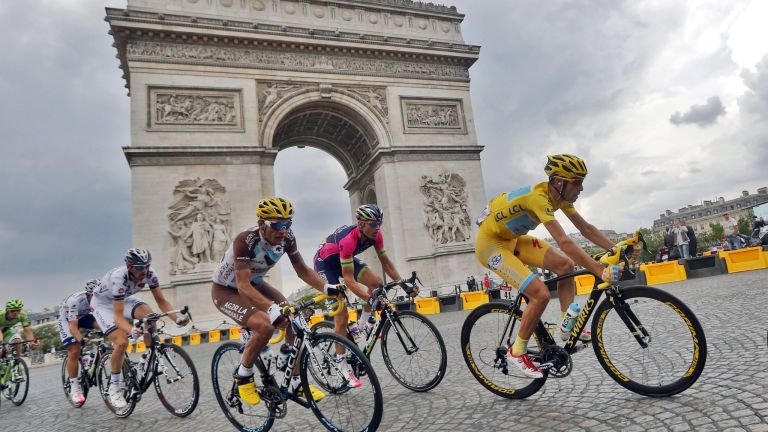cyclists passing near Arc the Triomphe, Paris